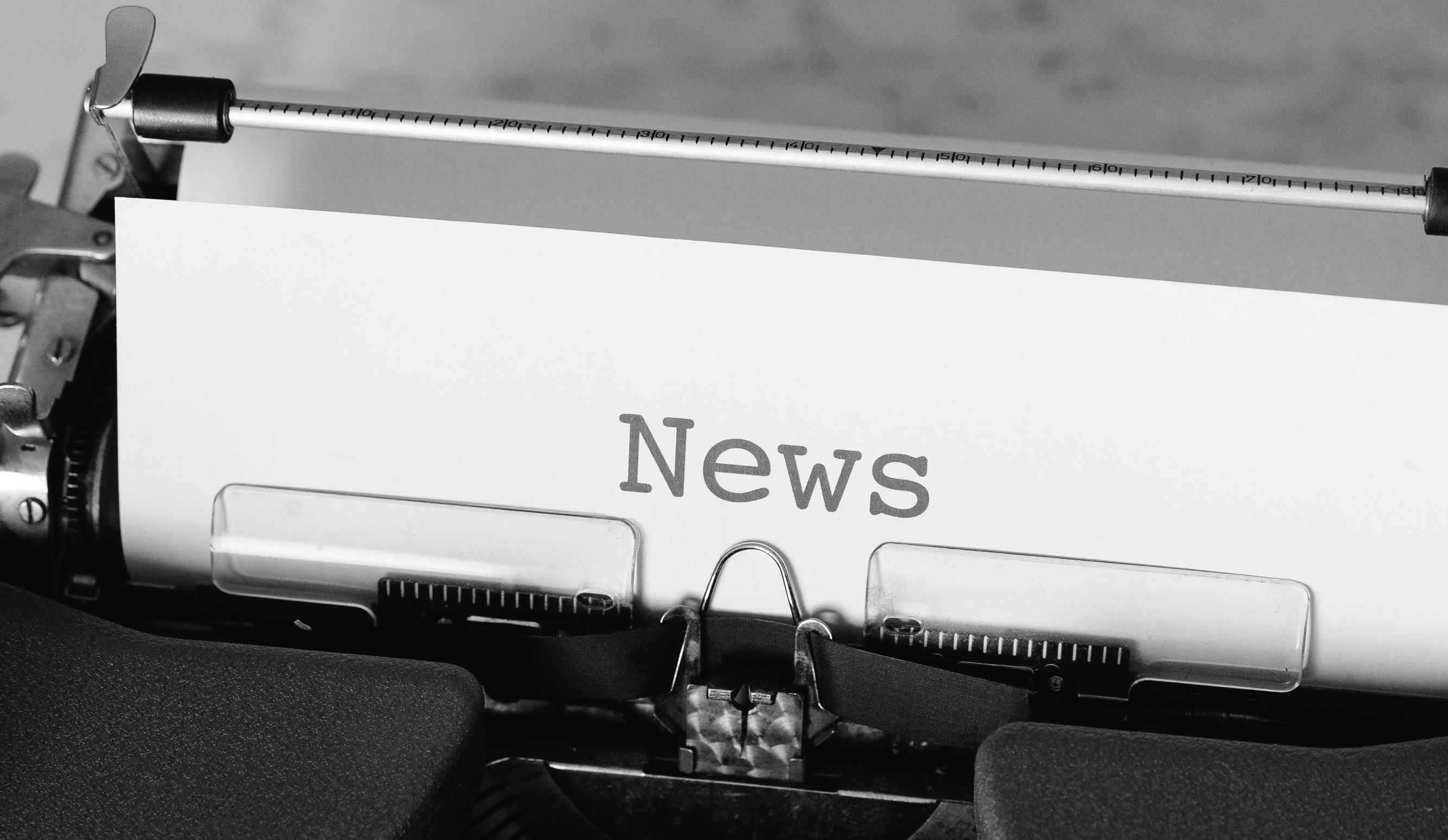 Typewriter with "News" typed on paper.